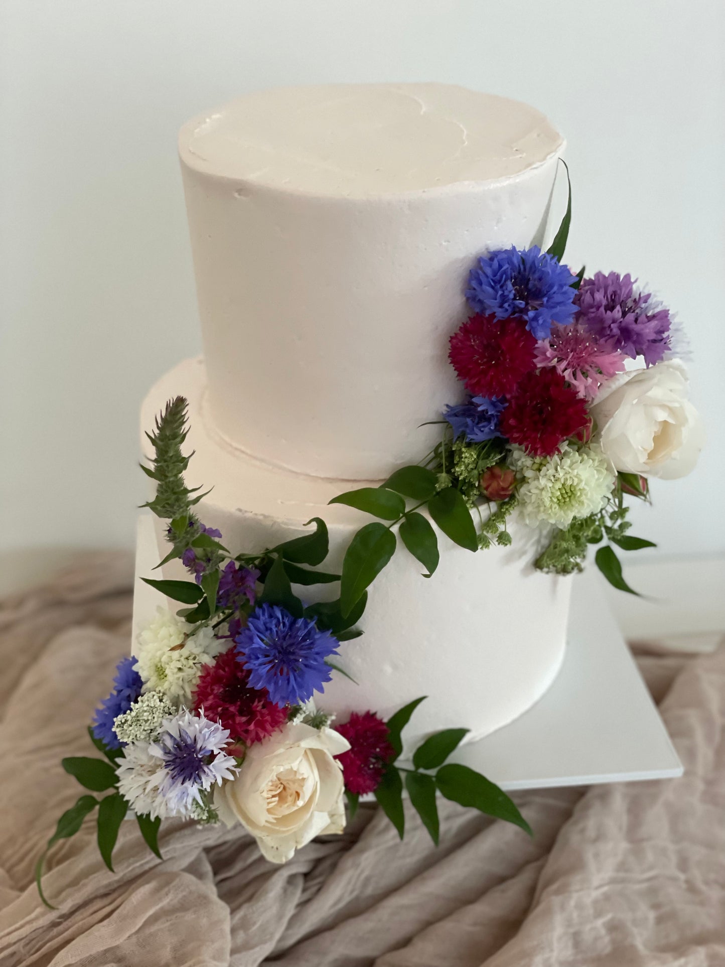 2 Tier Pale Pink Buttercream with Bright Flowers