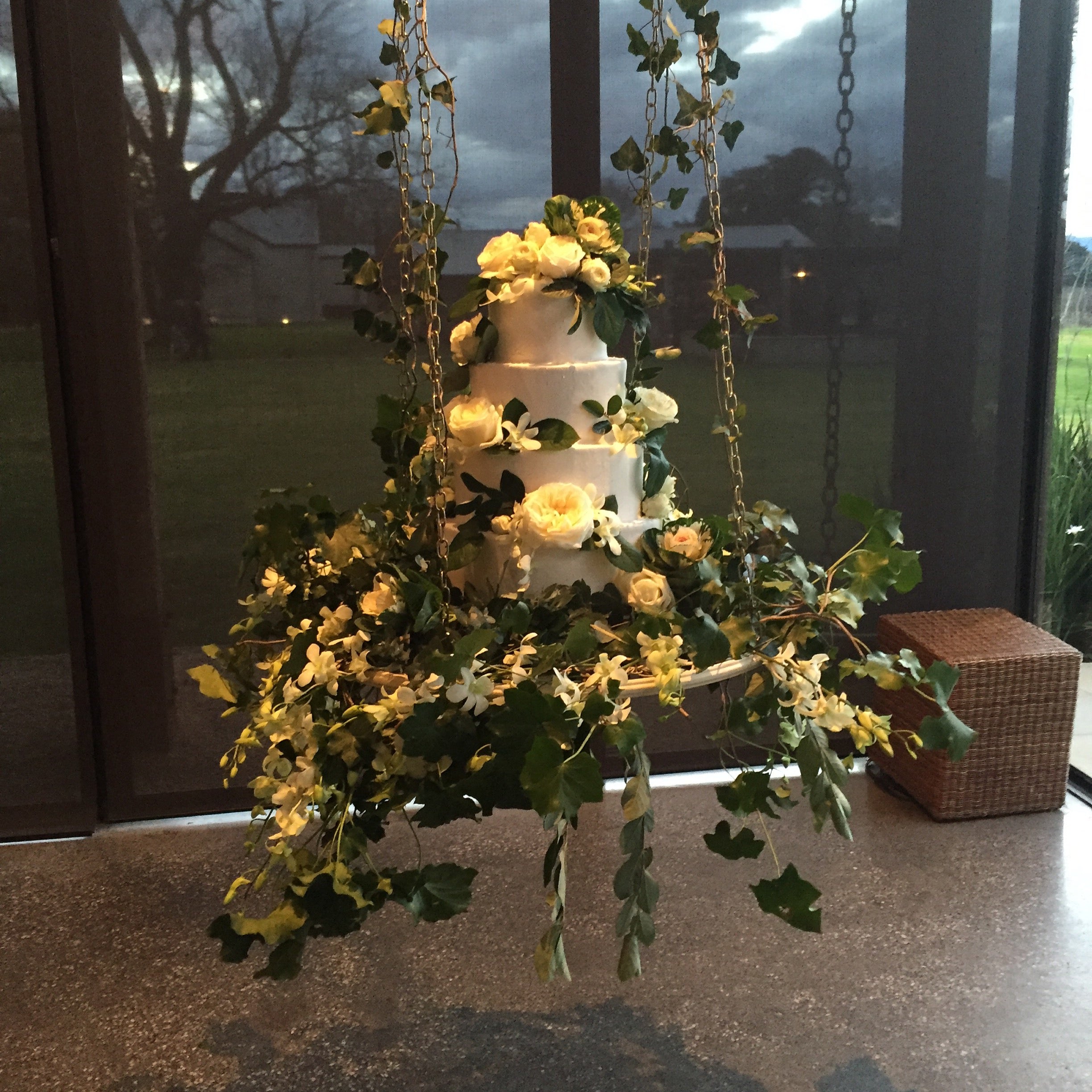 Photo of White hanging chandelier cake with smaller cakes