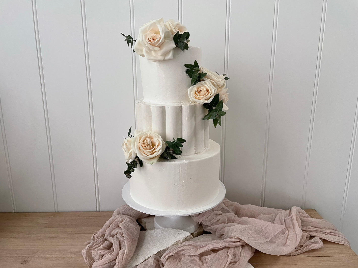 3 Tier Scollop Buttercream cake with white flowers