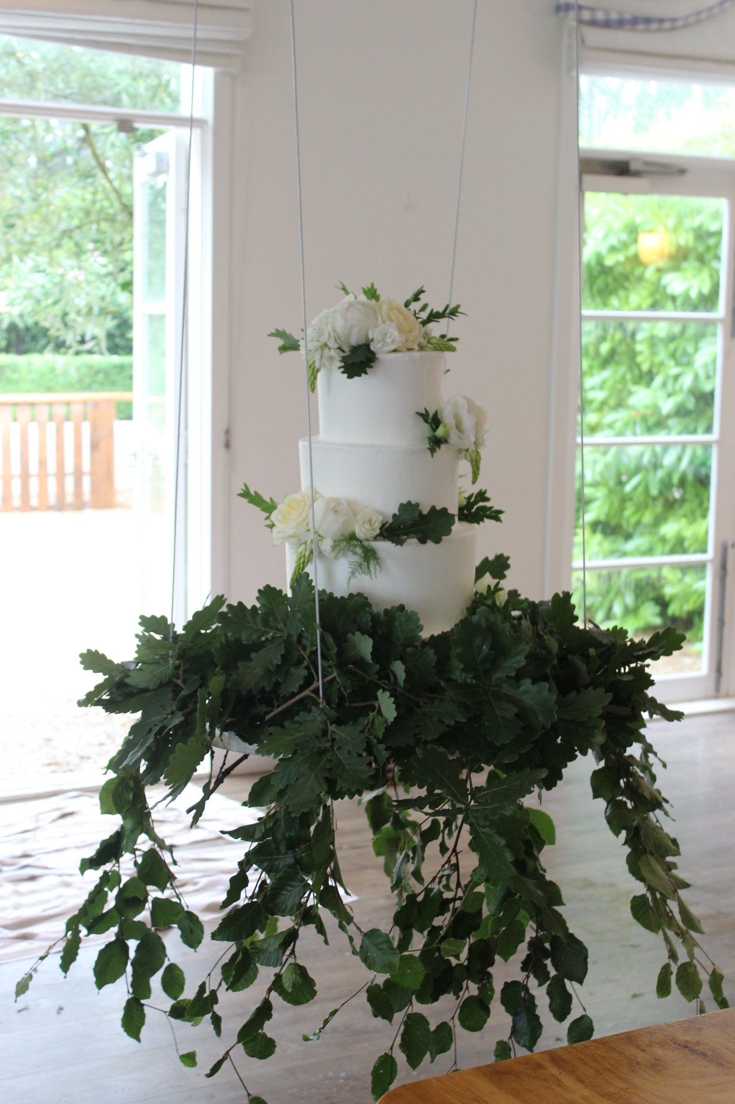 Hanging 4 Tier Smooth Buttercream with White & Green Flowers