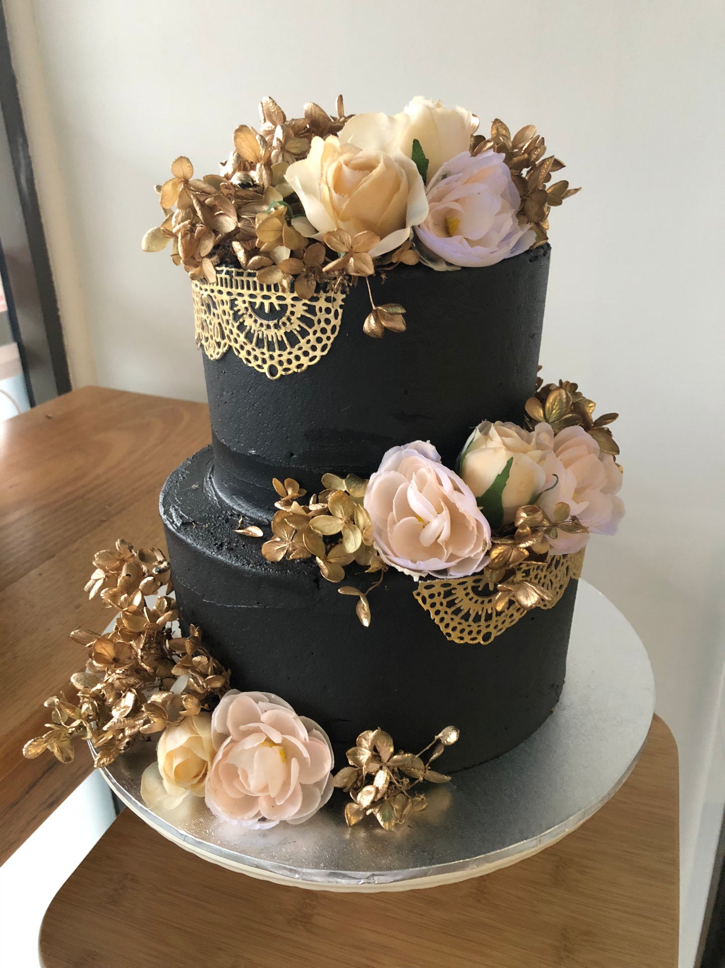 2 Tier Black Buttercream with Gold Lace & Flowers