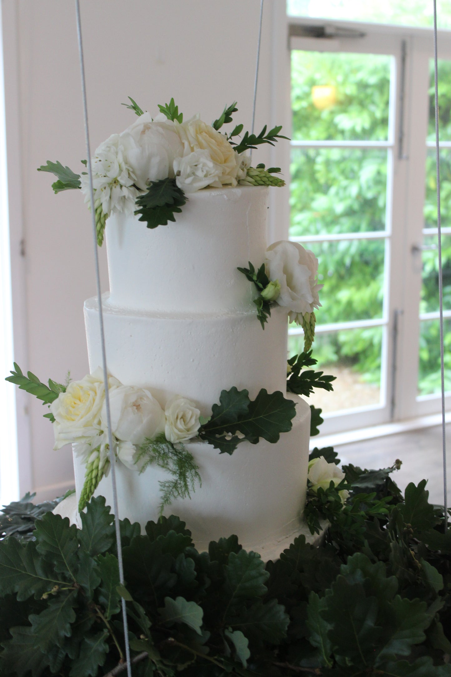 Hanging 4 Tier Smooth Buttercream with White & Green Flowers