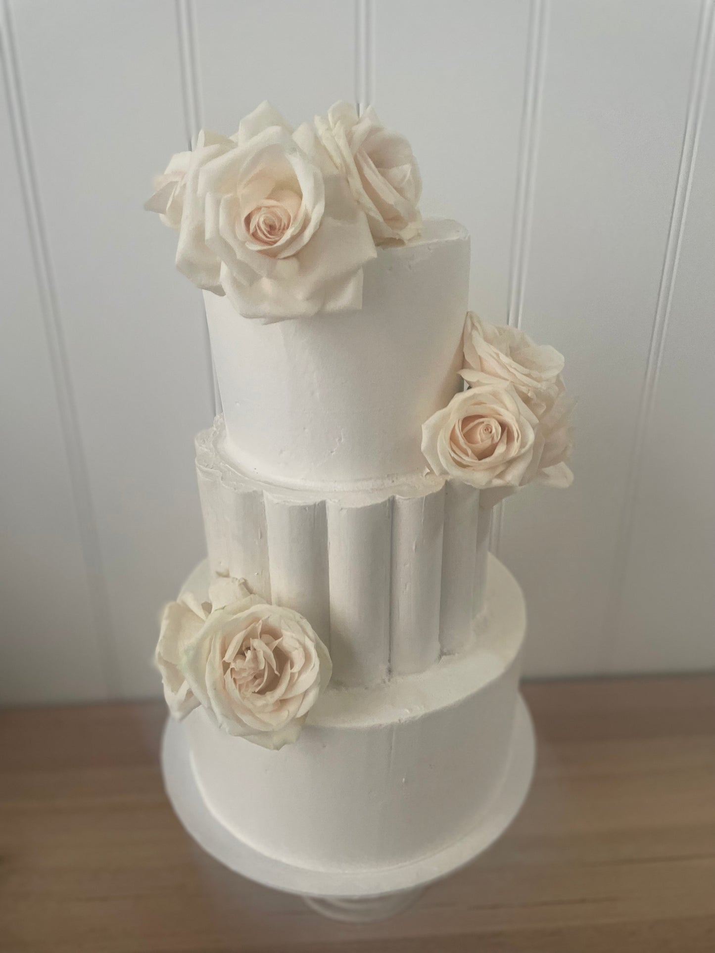 3 Tier Scollop Buttercream cake with white flowers